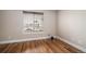 Cozy bedroom featuring hardwood floors and a large window offering plenty of sunlight at 1076 Switch Grass Dr, Castle Rock, CO 80109