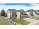 Two-story home featuring a well-maintained yard, brick accents, three-car garage and extended driveway at 1076 Switch Grass Dr, Castle Rock, CO 80109