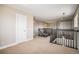 Open hallway featuring a carpeted floor, overhead lighting and a dark wood railing at 1076 Switch Grass Dr, Castle Rock, CO 80109