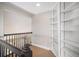 Upstairs hallway featuring carpet, railing, and built-in bookshelves at 1076 Switch Grass Dr, Castle Rock, CO 80109