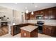 Modern kitchen with granite countertops, stainless steel appliances, and center island at 1076 Switch Grass Dr, Castle Rock, CO 80109