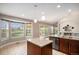 Open kitchen with a center island, stainless steel appliances, and sliding glass doors to the deck at 1076 Switch Grass Dr, Castle Rock, CO 80109