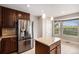 Stylish kitchen featuring stainless steel refrigerator, granite countertops, and center island at 1076 Switch Grass Dr, Castle Rock, CO 80109