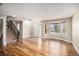 Bright living room featuring hardwood floors, bay window, and staircase at 1076 Switch Grass Dr, Castle Rock, CO 80109