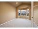 Cozy bedroom with a large bay window offering plenty of natural light and neutral carpet at 17118 Knollside Ave, Parker, CO 80134