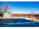 Large backyard featuring a storage shed and garden beds, ideal for outdoor activities at 5747 E Monument Dr, Castle Rock, CO 80104