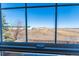 Scenic backyard view from the window showcasing a spacious yard and distant landscape at 5747 E Monument Dr, Castle Rock, CO 80104