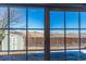 Beautiful backyard view through sliding glass doors, connecting indoor and outdoor living spaces at 5747 E Monument Dr, Castle Rock, CO 80104