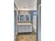 An elegant bathroom featuring dual sinks, sleek countertops, and stylish tiled flooring at 5747 E Monument Dr, Castle Rock, CO 80104