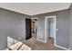 A carpeted bedroom shows access to the bathroom and closet at 5747 E Monument Dr, Castle Rock, CO 80104