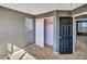 A carpeted bedroom features a small closet and access to other rooms at 5747 E Monument Dr, Castle Rock, CO 80104