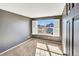 A gray bedroom features a large window, a door, and carpeted floors at 5747 E Monument Dr, Castle Rock, CO 80104