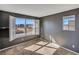 A carpeted bedroom with a large window that allows light in at 5747 E Monument Dr, Castle Rock, CO 80104
