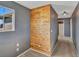 Hallway featuring a wood accent wall and access to other rooms in the home at 5747 E Monument Dr, Castle Rock, CO 80104