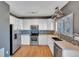 Updated kitchen featuring stainless steel appliances, white cabinetry, and stylish backsplash at 5747 E Monument Dr, Castle Rock, CO 80104