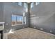 Spacious living room featuring high ceilings, large windows with shutter blinds, and plush carpeting at 5747 E Monument Dr, Castle Rock, CO 80104