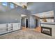 Inviting living room with a cozy fireplace, built-in shelving, and seamless flow to the kitchen area at 5747 E Monument Dr, Castle Rock, CO 80104