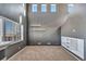 Bright living room with soaring ceilings, large windows, and stylish built-in shelving at 5747 E Monument Dr, Castle Rock, CO 80104