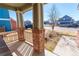 Inviting front porch with brick pillars, perfect for relaxing and enjoying the neighborhood view at 5747 E Monument Dr, Castle Rock, CO 80104