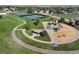 Aerial view of a community park featuring a playground, tennis courts, and walking paths at 10792 Moore St, Broomfield, CO 80021