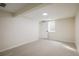 Unfinished basement area featuring neutral carpeting and a window at 10792 Moore St, Broomfield, CO 80021