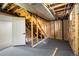 Unfinished basement featuring gray painted floors, exposed ductwork, and framed walls ready to be finished at 10792 Moore St, Broomfield, CO 80021