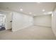 Spacious basement featuring recessed lighting, neutral carpet, and multiple access doors at 10792 Moore St, Broomfield, CO 80021