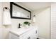Stylish bathroom featuring a double sink vanity with black hardware and a large mirror at 10792 Moore St, Broomfield, CO 80021
