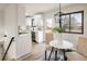 Cozy dining area featuring modern lighting, hardwood floors, and comfortable seating next to the kitchen at 10792 Moore St, Broomfield, CO 80021