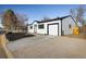 Side view of house with driveway and a single car garage. Newly landscaped front yard at 10792 Moore St, Broomfield, CO 80021