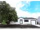 Charming single-story home with white siding, black trim, well-maintained landscaping, and a lovely front yard tree at 10792 Moore St, Broomfield, CO 80021