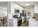 Modern kitchen features white cabinets, stainless steel appliances, and stylish countertops, offering a sleek design at 10792 Moore St, Broomfield, CO 80021