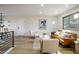 Bright living room with hardwood floors, neutral paint, and a leather sofa, creating an inviting space at 10792 Moore St, Broomfield, CO 80021