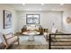 Cozy living room showcases hardwood floors, lots of seating, and natural lighting at 10792 Moore St, Broomfield, CO 80021