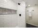 Modern shower with white subway tile, a built-in niche, and black hardware at 10792 Moore St, Broomfield, CO 80021