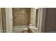 This bathroom features tile shower surround and vanity sink at 12170 Huron St # 106, Denver, CO 80234