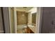 Well-lit bathroom featuring a shower-tub combo, tiled walls, and a vanity with a sink and mirror at 12170 Huron St # 106, Denver, CO 80234