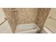 Clean bathtub featuring tiled walls and chrome fixtures at 12170 Huron St # 106, Denver, CO 80234