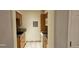 Galley kitchen featuring tile backsplash, laminate counters and appliances at 12170 Huron St # 106, Denver, CO 80234