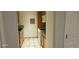 Galley kitchen featuring tile backsplash, laminate counters and appliances at 12170 Huron St # 106, Denver, CO 80234
