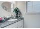 Clean bathroom with a granite countertop, decorative mirror, and a stylish faucet at 38025 E 145Th Pl, Keenesburg, CO 80643