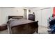 Inviting bedroom with a dark wood bed frame and double closet, perfect for relaxation at 38025 E 145Th Pl, Keenesburg, CO 80643