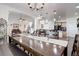 Elegant dining room with a long wooden table, stylish decor, and ample seating at 38025 E 145Th Pl, Keenesburg, CO 80643