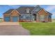 Charming home with stone accents, blue siding, and a well-manicured lawn on a sunny day at 38025 E 145Th Pl, Keenesburg, CO 80643