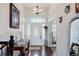 Welcoming foyer with hardwood floors, an ornate chandelier, and a decorative front door at 38025 E 145Th Pl, Keenesburg, CO 80643