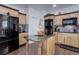 Well-equipped kitchen with wood cabinets, granite countertops, and a black refrigerator at 38025 E 145Th Pl, Keenesburg, CO 80643