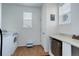 Functional laundry room with ample counter space, storage and natural light from windows at 38025 E 145Th Pl, Keenesburg, CO 80643