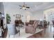 Comfortable living room with vaulted ceilings, leather seating, and hardwood floors at 38025 E 145Th Pl, Keenesburg, CO 80643