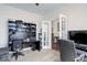 Functional office space with built-in shelving, carpeted floors, and ample natural light at 38025 E 145Th Pl, Keenesburg, CO 80643