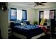 Bedroom featuring a bed with blue comforter, bright natural light, and ceiling fan at 1375 N Iola St, Aurora, CO 80010